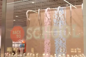 Retail storefront window with a back to school themed display