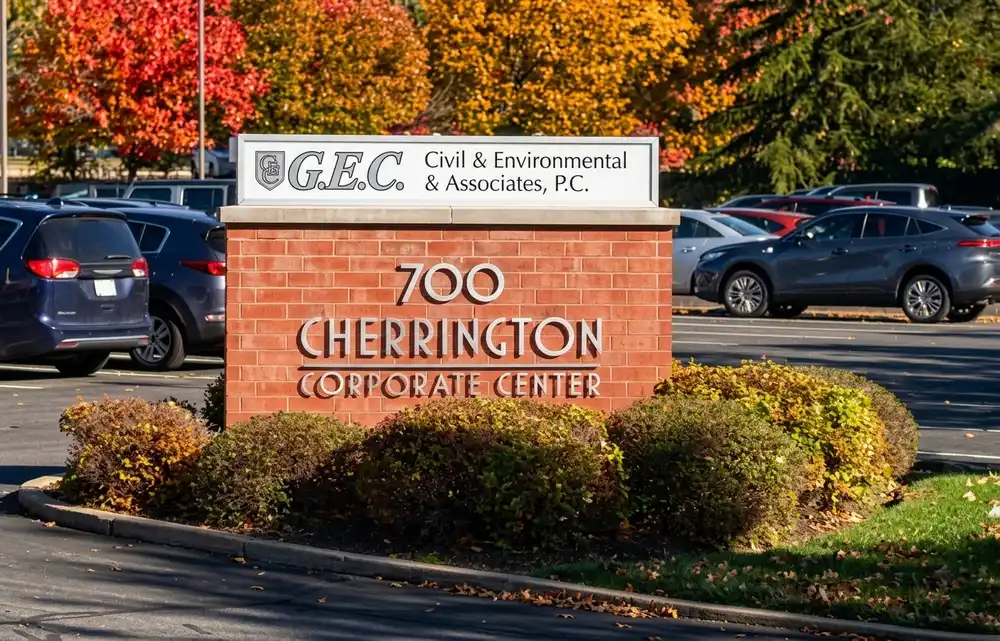 Brick monument sign for 700 Cherrington Corporate Center with a tenant panel for GEC Civil and Environmental Associates surrounded by fall foliage landscaping, installed by Spark Signs in Moon Township PA