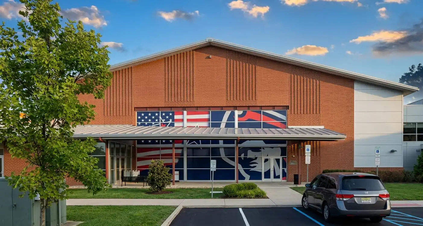 Large format window graphics with patriotic American flag and bold graphic design covering the full-width storefront windows of a brick commercial building, by Spark Signs in Moon Township PA
