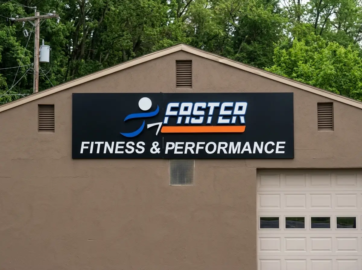 Large flat panel building sign for Faster Fitness and Performance mounted on the exterior wall of a commercial building in Robinson Township PA, by Spark Signs