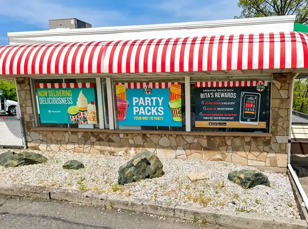 Full-panel window graphics for Rita's Italian Ice storefront advertising delivery, party packs, and rewards program, installed by Spark Signs in Robinson Township PA