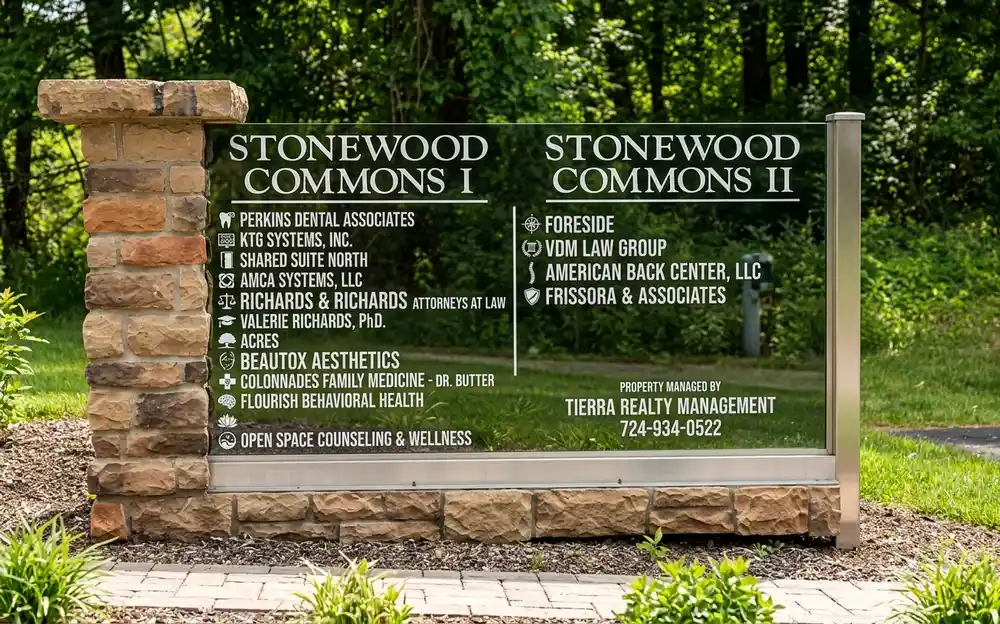 Multi-tenant directory monument sign on a stone pillar base listing businesses at Stonewood Commons I and II, installed by Spark Signs in Warrendale PA