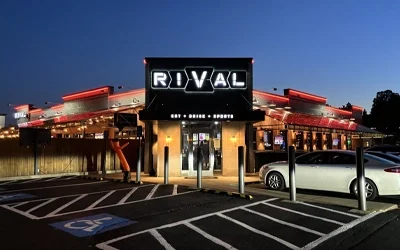 Exterior illuminated channel letter sign on restaurant building at night